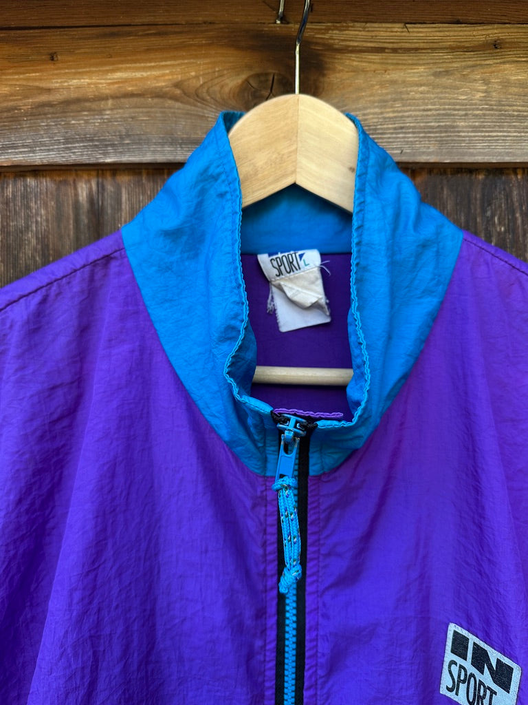 Purple and blue jacket with IN SPORT label on a wooden background