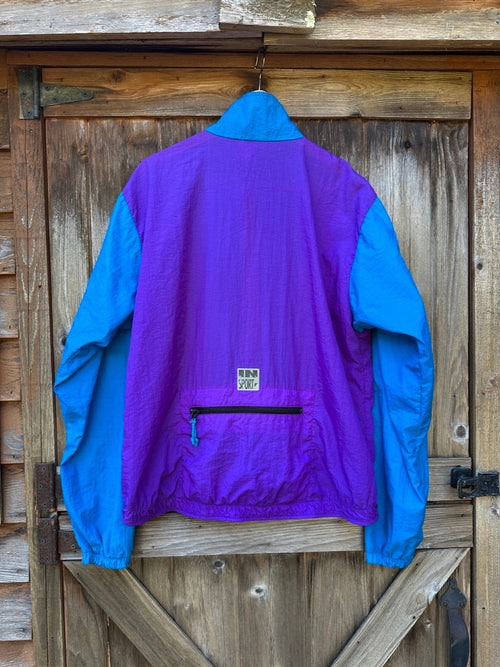 Purple and blue jacket hanging on a wooden door