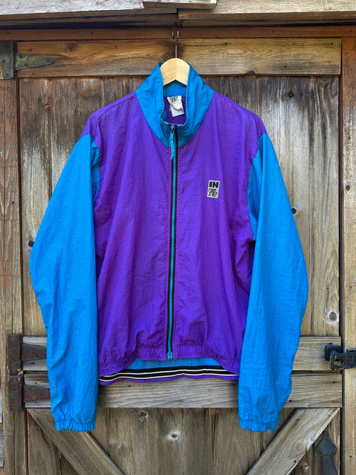 Purple and blue jacket hanging on a wooden door